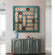 The Formexa Ring Geometric Wood Relief 3D Wall Art by Giant Sculptures showcases Nordic-inspired circles in pink, red, and blue. Below it, a sleek green console table displays a small sculpture and decorative items, enhancing the rooms contemporary style.