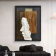 A modern living room features the Visagio Hand-Painted Wood Relief 3D Wall Art by Giant Sculptures, showcasing a sculpted side profile framed in black against Wabi-Sabi-inspired brown and beige panels, with a black couch and dark cushions adding to the serene look.