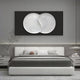 A modern bedroom features a large white bed with striped pillows and a gray blanket, adorned by the Artivio Black & White Wood Relief 3D Wall Art from Giant Sculptures above it. Minimalist decor includes small plants on the nightstands and a sleek pendant light.