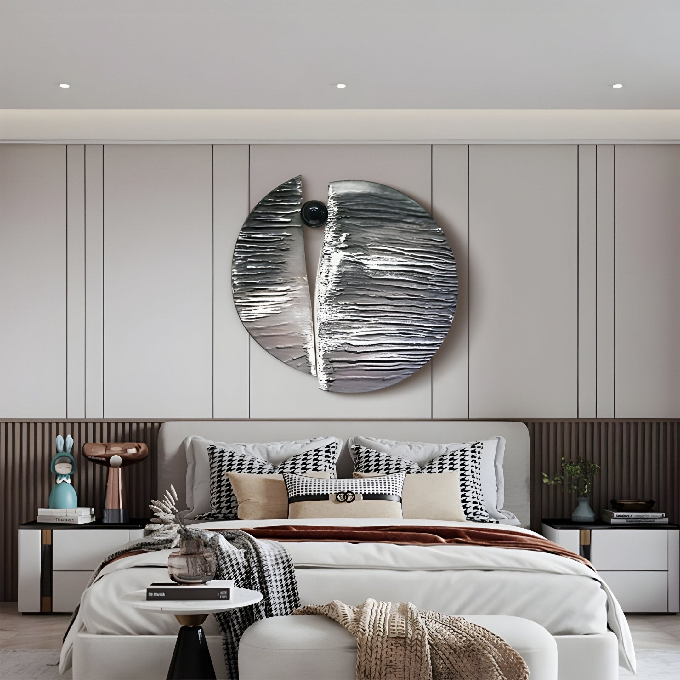 A modern bedroom showcases the Argentum Textured Wood Relief 3D Wall Art With Black Metal Ball by Giant Sculptures above a neatly made bed with patterned pillows and a brown throw blanket. Two nightstands hold decorative items, enhancing the depth of the neutral-toned walls.