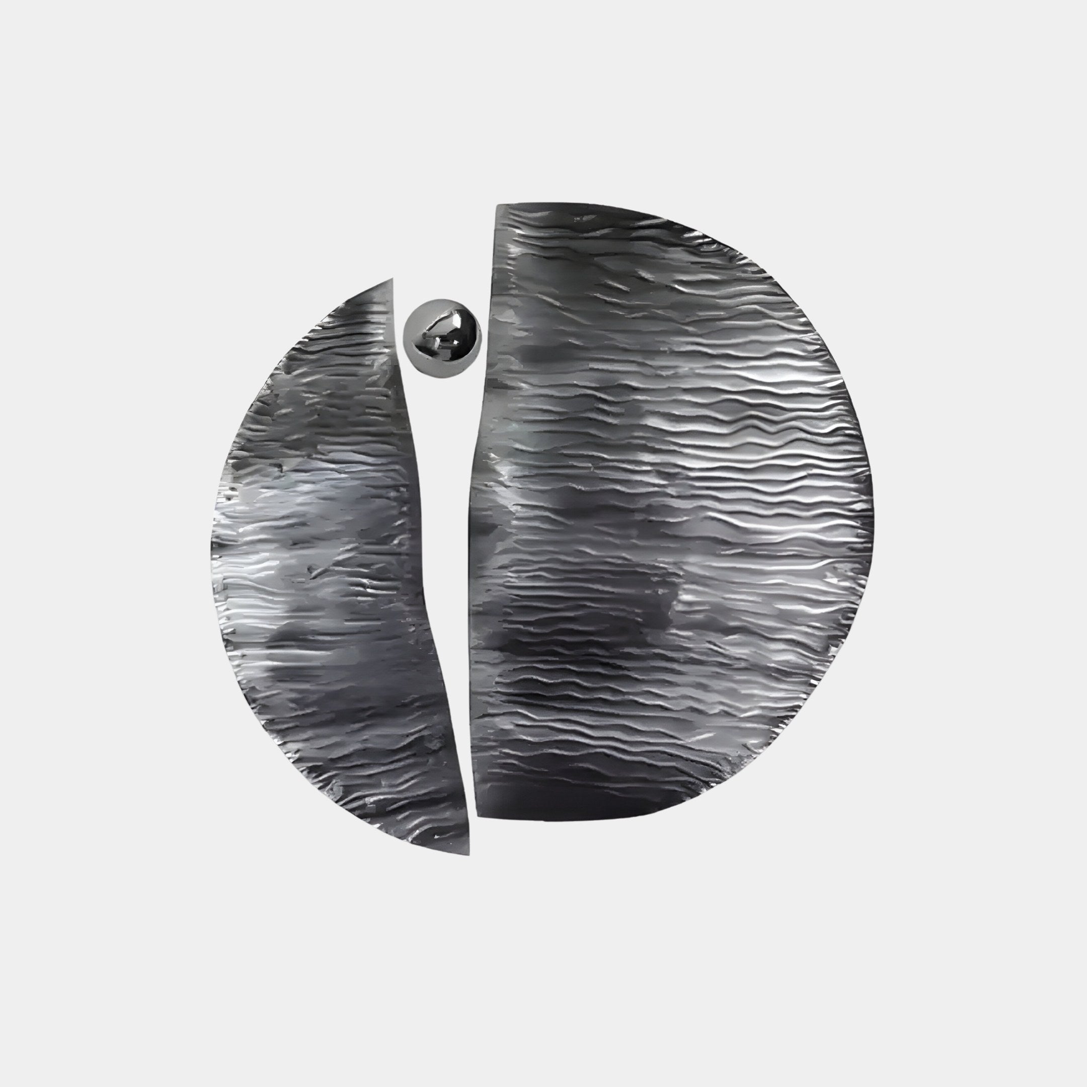 The Argentum Textured Wood Relief 3D Wall Art by Giant Sculptures is a circular, metallic piece with a wavy, ripple-like surface that splits into two. A silver metal ball is positioned just off-center from the divide.