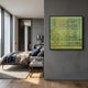 A modern bedroom with a neatly made bed, wooden floor, and large windows features the Vectaryn Green Abstract Embossed Texture 3D Wall Art by Giant Sculptures on a gray wall. A small desk with books and a lamp sits near the bed, enhancing the Nordic vibe.
