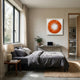 Plumesse Amber Bloom Layered Feather 3D Wall Art by Giant Sculptures hung above a console in a modern bedroom with grey linen bedding and a large window.