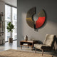 A modern living room featuring Giant Sculptures' Vortaryn Ember & Rust Circle 3D Wall Art, an armchair with a cushion, a wooden side table with decor, a potted plant, and natural light streaming through the window.