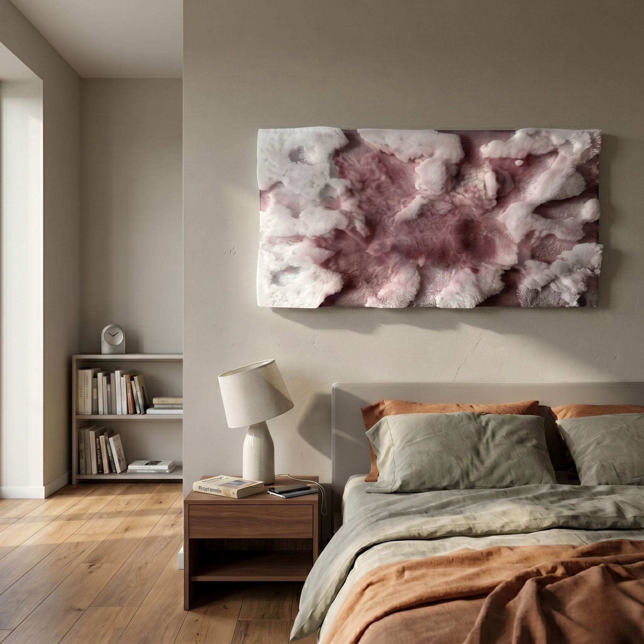 A cozy bedroom with neutral walls, green and brown bedding, a wooden nightstand and lamp, a shelf of books, and the Nivara Rose Mist Ripple Straw 3D Wall Art by Giant Sculptures above the bed. Natural light fills this stylish contemporary space.