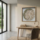 A minimal home office with a wooden desk, books, and a modern lamp features Giant Sculptures' Arborique Golden Crest Steel & Wood Slice 3D Wall Art above the desk. Large windows bring in light, while a textured chair and rug finish the look.