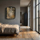 Solarien Aureate Burst Sculptural 3D Wall Art by Giant Sculptures mounted above a linen-dressed bed in a grey bedroom with wood floors and tall windows.