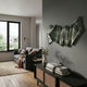Vellun Wave Sage Flow Sculptural Hand-Painted 3D Wall Art by Giant Sculptures, with green striped ribbon folds mounted on a grey wall above a cane-front sideboard.