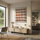 Giant Sculptures Orbivelle Amber-Silver Patch Sphere & White Panel 3D Wall Art mounted above a pale wood sideboard in a sunlit modern living room.
