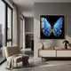 Auravalor Blue Butterfly Crystal Porcelain 3D Wall Art in a gold frame, displayed above a wooden console in a modern living room with a boucle chair.