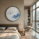 Yunsei Misty Pavilion Vista Round Silk Relief 3D Wall Art by Giant Sculptures hung above a bed in a sunlit modern bedroom with armchair and bookshelf.