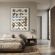 Orbivelle Gold Split Sphere & White Panel 3D Wall Art by Giant Sculptures displayed above a linen bed and wooden nightstand in a minimalist bedroom.