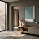 Giant Sculptures Linscape Green Linear Wood Relief 3D Wall Art in a slim frame, mounted above a wooden console with pampas grass in a modern grey-walled hallway.