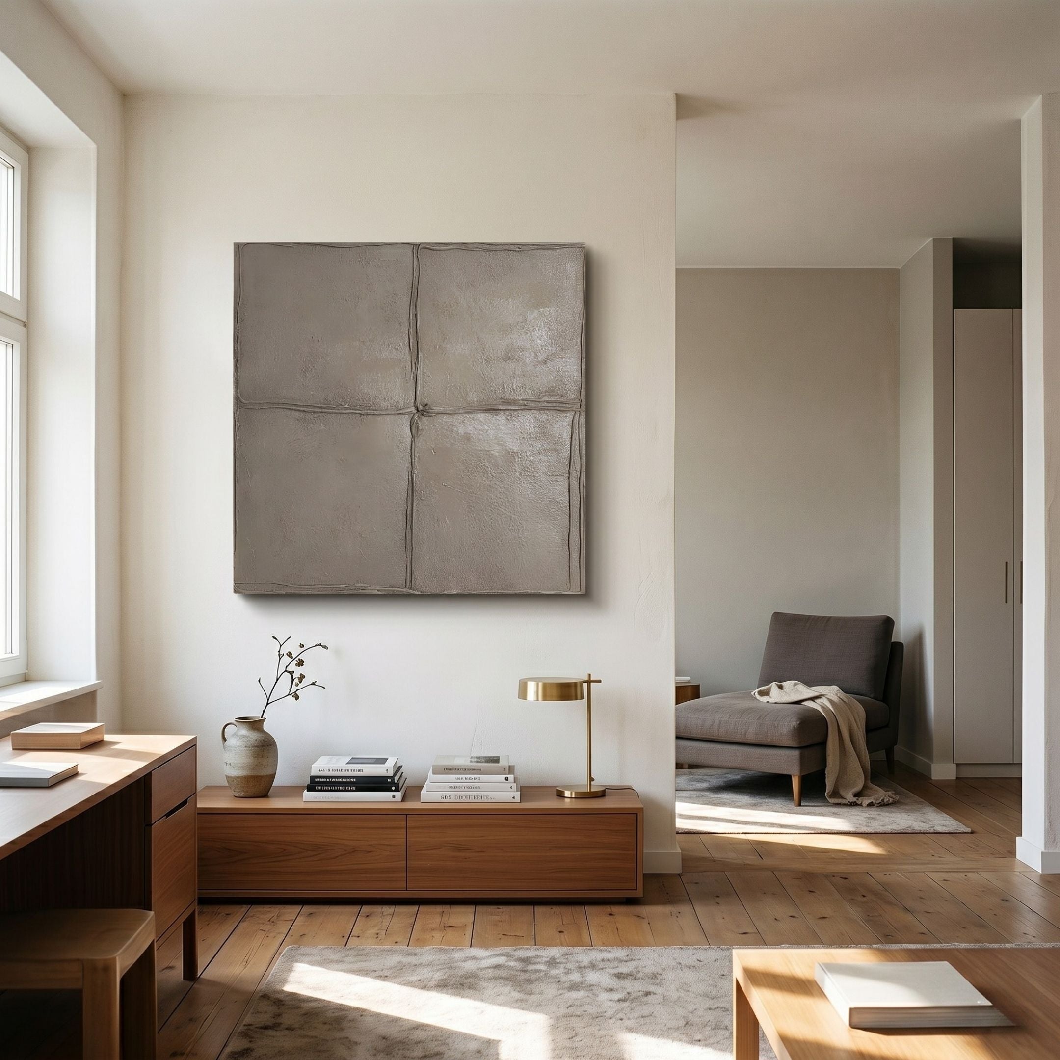 Giant Sculptures Terracrecta Taupe Painted Textured Square 3D Wall Art mounted above a wooden console in a minimalist living room with a grey armchair.