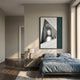 Arclustre Teal & White Archway Perspective 3D Wall Art by Giant Sculptures displayed above a blue-linen bed with a bedside lamp in a sunlit bedroom.