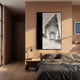 Arclustre Black & White Cathedral Vault 3D Wall Art by Giant Sculptures hung above a wooden nightstand in a terracotta-toned bedroom with a linen-dressed bed.