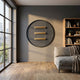 Straylight Charcoal Black Tiered Bar Round 3D Wall Art by Giant Sculptures mounted on a grey wall in a modern living room with sofa and bookshelf.