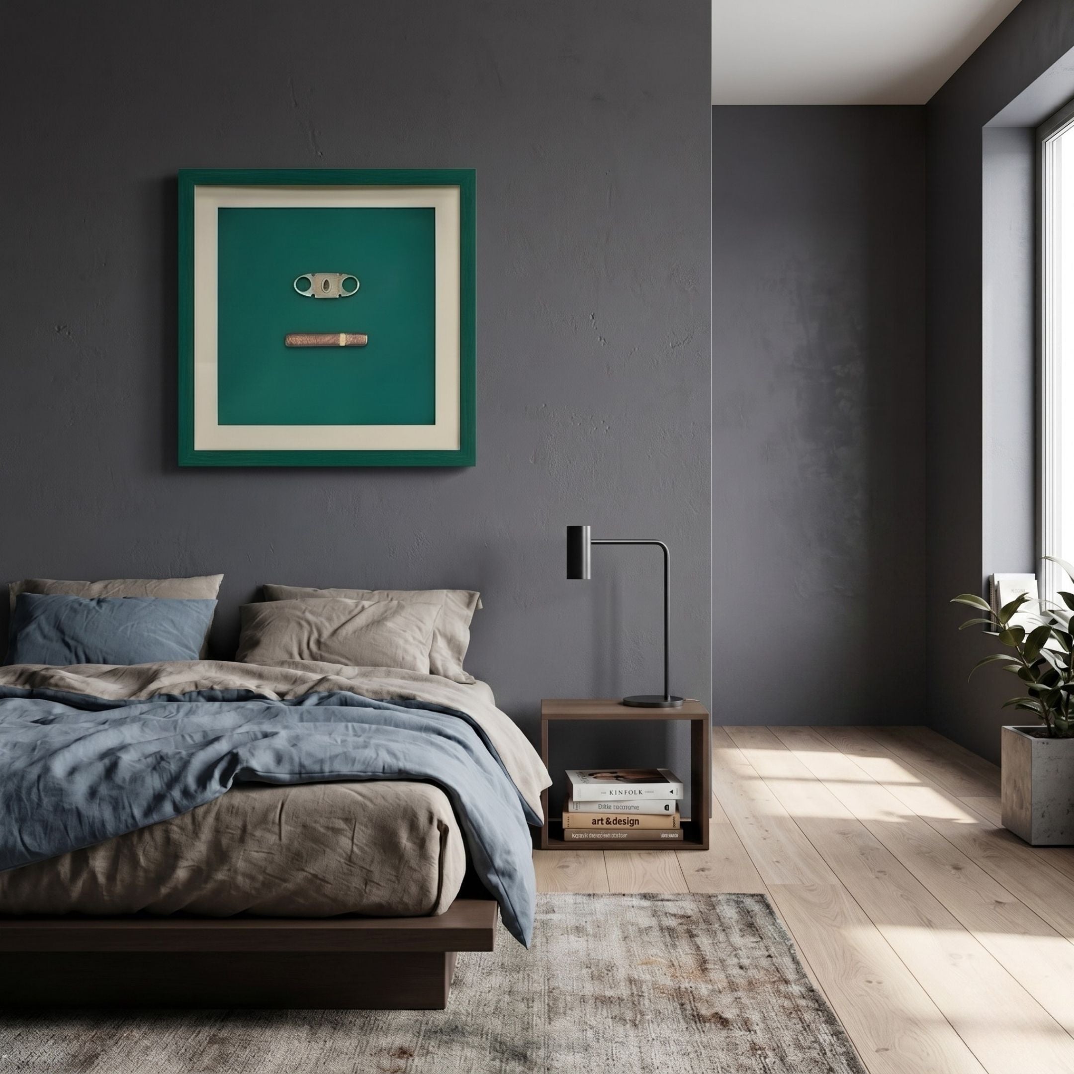 Cavallero Green Cigar & Cutter Framed Wall Art by Giant Sculptures hung above a bed with grey and blue linens in a modern dark-walled bedroom.