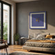 Cavallero Blue Cigar & Cutter Framed Wall Art by Giant Sculptures displayed above a bed in a modern bedroom with a snake plant, side table, and balcony view.