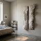 Bristella White Textured 2-Panel 3D Wall Art by Giant Sculptures mounted in a minimalist bedroom with linen bedding, a low bookshelf, and concrete floor.