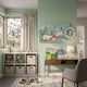 Everwyn Tales Celestial Deer Enchanted Valley 3D Wall Art displayed on a sage green nursery wall above a wooden desk, beside toy storage and a curtained window.