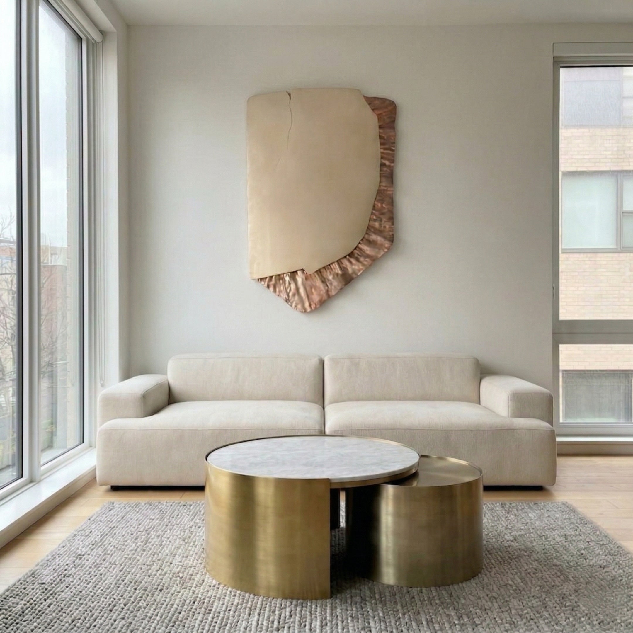 Gildrift Gold Steel & Copper Ridge Textured 3D Wall Art by Giant Sculptures mounted above a cream sofa in a modern living room with brass coffee tables and a woven rug.