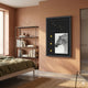 Curatoria Equestrian Emblem & Horse Portrait Framed Wall Art with riding crop, three gold medallions, and grayscale horse, hung in a terracotta bedroom.