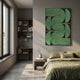 Curvanta Green Loop Geometric 3D Wall Art with mirrored curves and gold accents on black, displayed above a nightstand in an olive-toned bedroom.