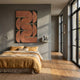 Curvanta Brown Loop Geometric 3D Wall Art by Giant Sculptures mounted above a bed dressed in mustard linen in a grey bedroom with oak floors.