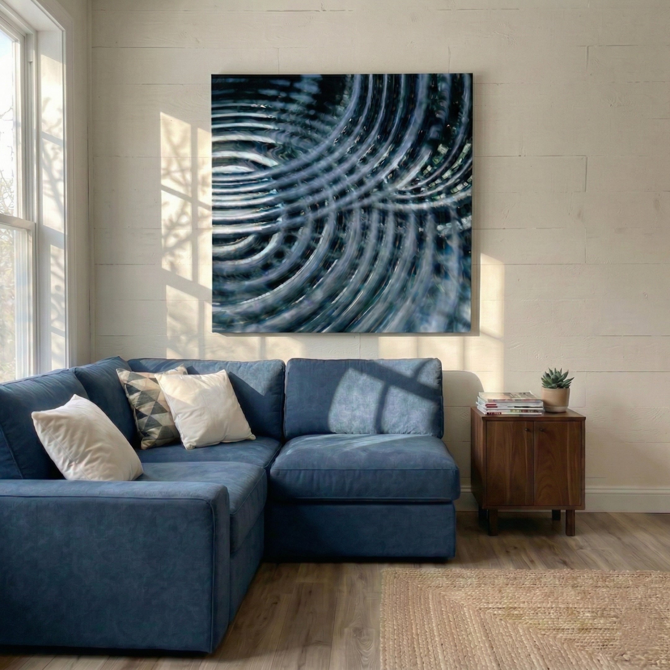 Rillora Blue Ribbed Wood Carving 3D Wall Art by Giant Sculptures mounted above a blue sectional sofa in a sunlit living room with wood flooring and a walnut side table.