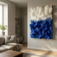 Chromavolt Blue & White Straw 3D Wall Art by Giant Sculptures mounted on a beige living room wall above a linen sofa, with fluffy white upper band over electric blue.