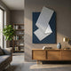 Arcluma Midnight Blue Stripe Fold Leather 3D Wall Art by Giant Sculptures displayed above a wooden sideboard in a modern living room with bookshelf and plant.