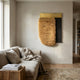 Halvoria Grey & Sand Fibre Panel 3D Wall Art by Giant Sculptures, with sand-toned fibre, ribbed dark grey panel and gold bar, displayed above a linen sofa.
