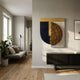 Halvoria Black & Umber Fibre Shield 3D Wall Art by Giant Sculptures displayed on a cream hallway wall above a dark console, near a linen sofa.