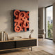 Typova Red X&O Wood Carving 3D Wall Art by Giant Sculptures, layered red carved symbols in a deep blue box frame, mounted above a wooden sideboard.