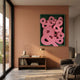Typova Pink Ampersand Wood Carving 3D Wall Art by Giant Sculptures, with layered pink ampersands in a green tray frame above a wooden console in a terracotta-walled living room.