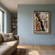Volaris Ochre & Ivory Rolled Floral Framed 3D Wall Art in a wooden frame mounted on a pale blue living room wall above a linen sofa near a bookshelf.