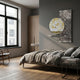 Aurivista Gold Mountain & Silver Abstract Panel 3D Metal Wall Art mounted on a grey bedroom wall above a shelf, beside a bed and wooden wardrobe.