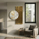Aurivista White & Gold Abstract Circle Panel 3D Metal Wall Art mounted in a neutral living room above a side table beside a grey armchair and window.