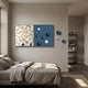 Spherium Blue & White Orb Dual-Tone Panel 3D Wall Art mounted above a bed, with orbs extending onto the wall beside a bookshelf.