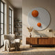 Orbiora IV Orange Duo Concentric Sphere 3D Wall Art by Giant Sculptures displayed above a walnut sideboard in a sunlit living room with boucle armchair.