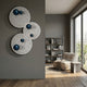 Orbiora Blue Orb 3-Panel Concentric Sphere 3D Wall Art by Giant Sculptures displayed on a grey wall beside a reading nook with armchair and bookshelf.