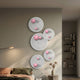 Orbiora Pink Orb 5-Panel Concentric Sphere 3D Wall Art by Giant Sculptures displayed on a bedroom wall above a bed, beside a floor lamp and bookshelf.