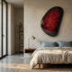Veyora Crimson Spark 3D Relief Wall Art by Giant Sculptures mounted above a bed with blue pillows, brass lamp, and walnut nightstand in a modern bedroom.