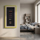 Tabacora Cigar Case & Accessories Framed 3D Wall Art by Giant Sculptures, with yellow and beige frame, mounted on a beige wall beside a modern bedroom.