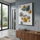 Orbienta I Multi-Tone Disc Cluster 3D Wall Art by Giant Sculptures with gold, silver, and teal metallic discs, mounted on a grey wall above a walnut sideboard.