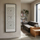 Lunaro White Jade Grid Vertical 3D Wall Art by Giant Sculptures displayed on a beige plaster wall beside a modern living room with grey sofa and bookshelf.