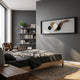 Erynoa Natural Branch & Woven Circle 3D Wall Art by Giant Sculptures mounted above a wooden bed in a modern grey bedroom with bookshelf and armchair.