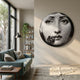 Lunoria Flower Face Round Wood Embossed Wall Art by Giant Sculptures displayed on a cream living room wall above a teal sofa, bookshelf, and floor lamp.