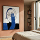 Cavoya Blue Gaze Figurative Crystal Porcelain Wall Art by Giant Sculptures displayed on a terracotta bedroom wall beside a bookshelf, floor lamp, and linen bed.
